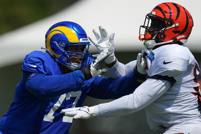 Los Angeles Rams offensive tackle AJ Jackson (77) and Cincinnati Bengals defensive end Cam Sample (96), right, participate in drills during a joint practice, Wednesday, Aug. 24, 2022, at the Paycor Stadium practice fields in Cincinnati.