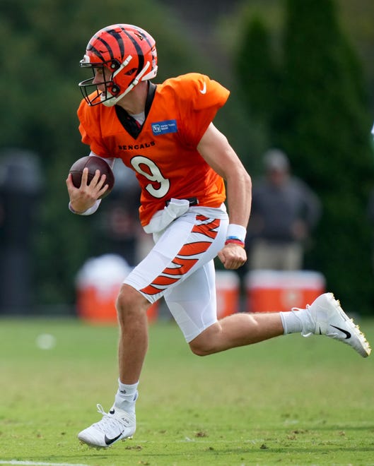 Cincinnati Bengals quarterback Joe Burrow (9) runs out of the pocke during a joint practice with the Los Angeles Rams, Wednesday, Aug. 24, 2022, at the Paycor Stadium practice fields in Cincinnati.