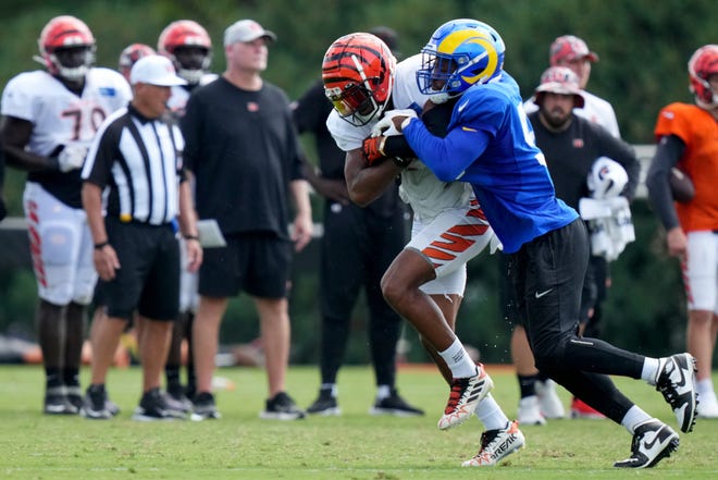 Cincinnati Bengals wide receiver Tyler Boyd (83) maintains possession as Los Angeles Rams linebacker Ernest Jones (53) defends during a joint practice, Wednesday, Aug. 24, 2022, at the Paycor Stadium practice fields in Cincinnati.