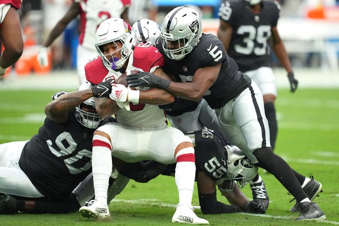 Sep 18, 2022; Paradise, Nevada, USA; Arizona Cardinals running back James Conner (6) is tackled by Las Vegas Raiders defensive tackle Johnathan Hankins (90) and Las Vegas Raiders linebacker Divine Deablo (5) during a game at Allegiant Stadium.