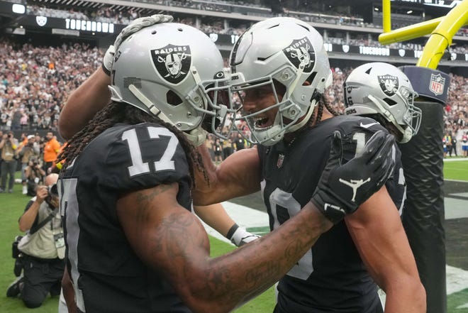 Sep 18, 2022; Paradise, Nevada, USA; Las Vegas Raiders wide receiver Davante Adams (17) celebrates with wide receiver Mack Hollins (10) after scoring a touchdown against the Arizona Cardinals in the first half at Allegiant Stadium.
