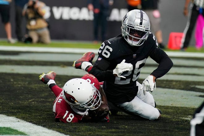 Arizona Cardinals wide receiver A.J. Green (18) makes a catch for a two-point conversion as time expires next to Las Vegas Raiders cornerback Rock Ya-Sin (26) during the fourth quarter of an NFL football game Sunday, Sept. 18, 2022, in Las Vegas.