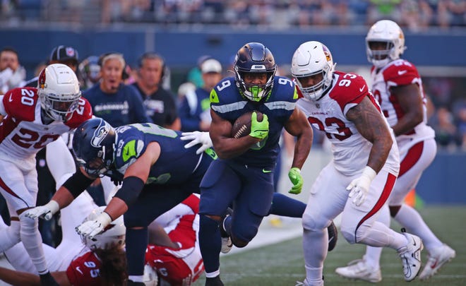 Kenneth Walker III #9 of the Seattle Seahawks runs against the Arizona Cardinals during the third quarter at Lumen Field on October 16, 2022, in Seattle, Washington.