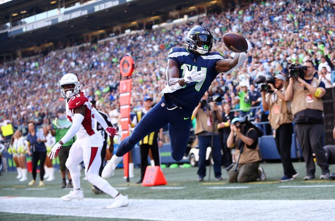 DK Metcalf #14 of the Seattle Seahawks can't pull in a pass against the Arizona Cardinals during the first half at Lumen Field on October 16, 2022, in Seattle, Washington.