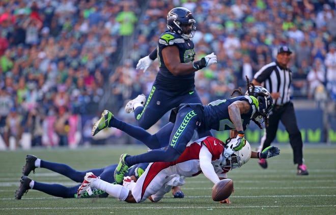 Travis Homer #25 of the Seattle Seahawks sacks Kyler Murray #1 of the Arizona Cardinals during the third quarter at Lumen Field on October 16, 2022, in Seattle, Washington.
