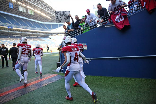 The Arizona Cardinals take the field for warm-ups against the Seattle Seahawks at Lumen Field on October 16, 2022, in Seattle, Washington.