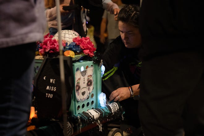 Amanda Porter breaks down her parade float at the 33rd Annual All Souls Procession in Tucson on Nov. 6, 2022. The procession is not a Day of the Dead-themed celebration, but an opportunity for community members to honor the dead through any tradition, said event parent organization and nonprofit Many Mouths One Stomach.