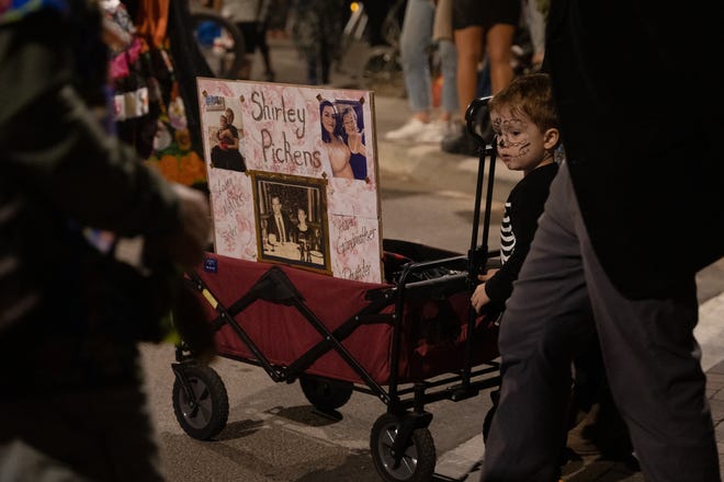 Glenn Hermosilla-Rose watches the 33rd Annual All Souls Procession in Tucson on Nov. 6, 2022. The procession is not a Day of the Dead-themed celebration, but an opportunity for community members to honor the dead through any tradition, said event parent organization and nonprofit Many Mouths One Stomach.