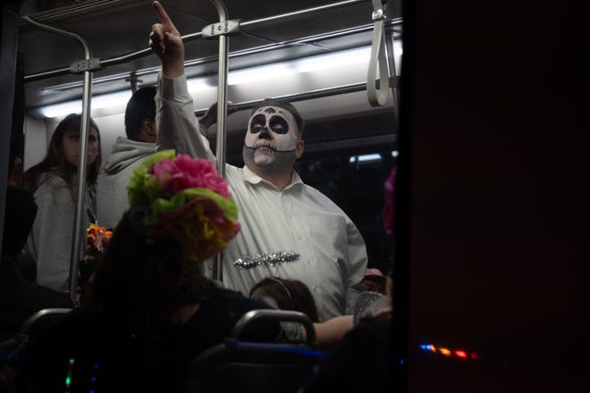 Daniel Reed rides the Sun Link streetcar after the 33rd Annual All Souls Procession in Tucson on Nov. 6, 2022. The procession is not a Day of the Dead-themed celebration, but an opportunity for community members to honor the dead through any tradition, said event parent organization and nonprofit Many Mouths One Stomach.
