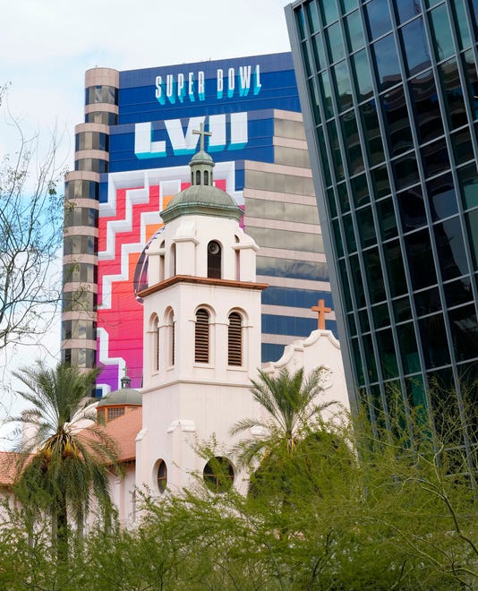 Super Bowl LVII signage covers a high-rise building behind St. Mary's Basilica in downtown Phoenix on Jan. 30, 2023.