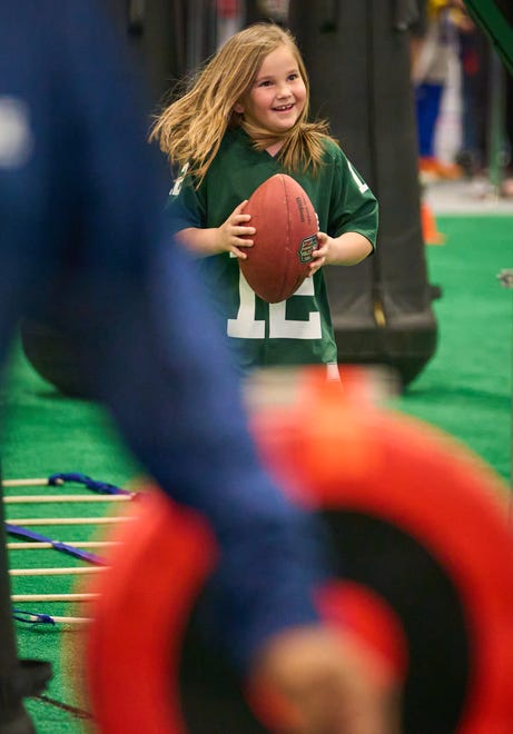 Sophia Stepanek, 6, participates in the quarterback scramble during the Super Bowl Experience at the Phoenix Convention Center on Feb. 5, 2023.