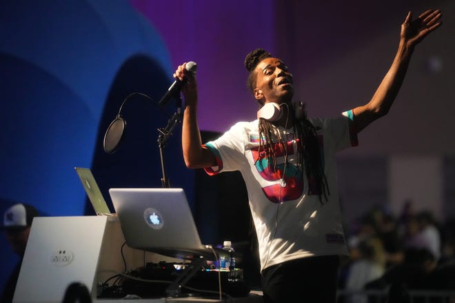 A DJ performs for attendees during the NFL's Super Bowl Experience at the Phoenix Convention Center on Feb. 4, 2023.