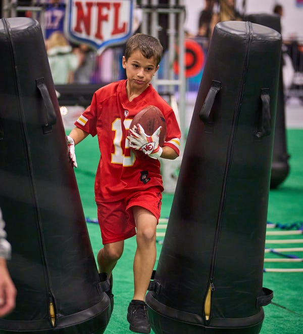 Matthew Dame, 9, participates in the quarterback scramble during the Super Bowl Experience at the Phoenix Convention Center on Feb. 5, 2023.
