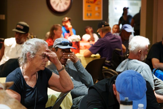 K.C. Griffin (left) sits in a crowded room at Justa Center, one of the valley's many cooling centers during a heat wave on July 16, 2023 in Phoenix.